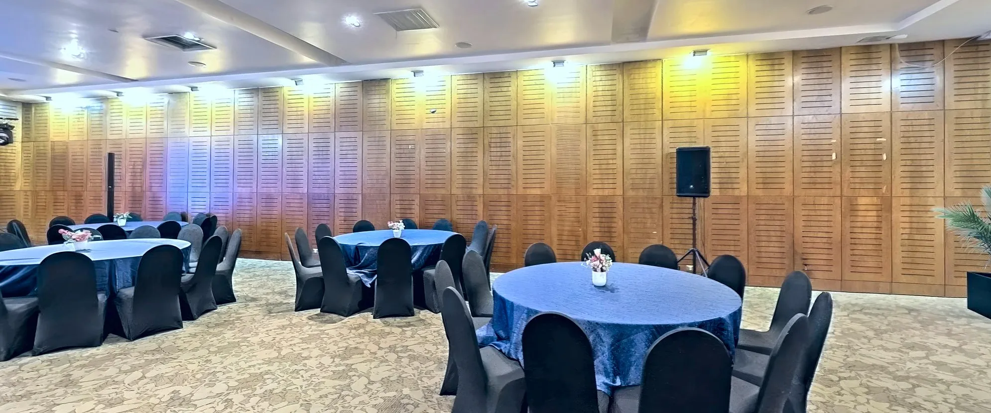An events hall set with round tables for a banquet