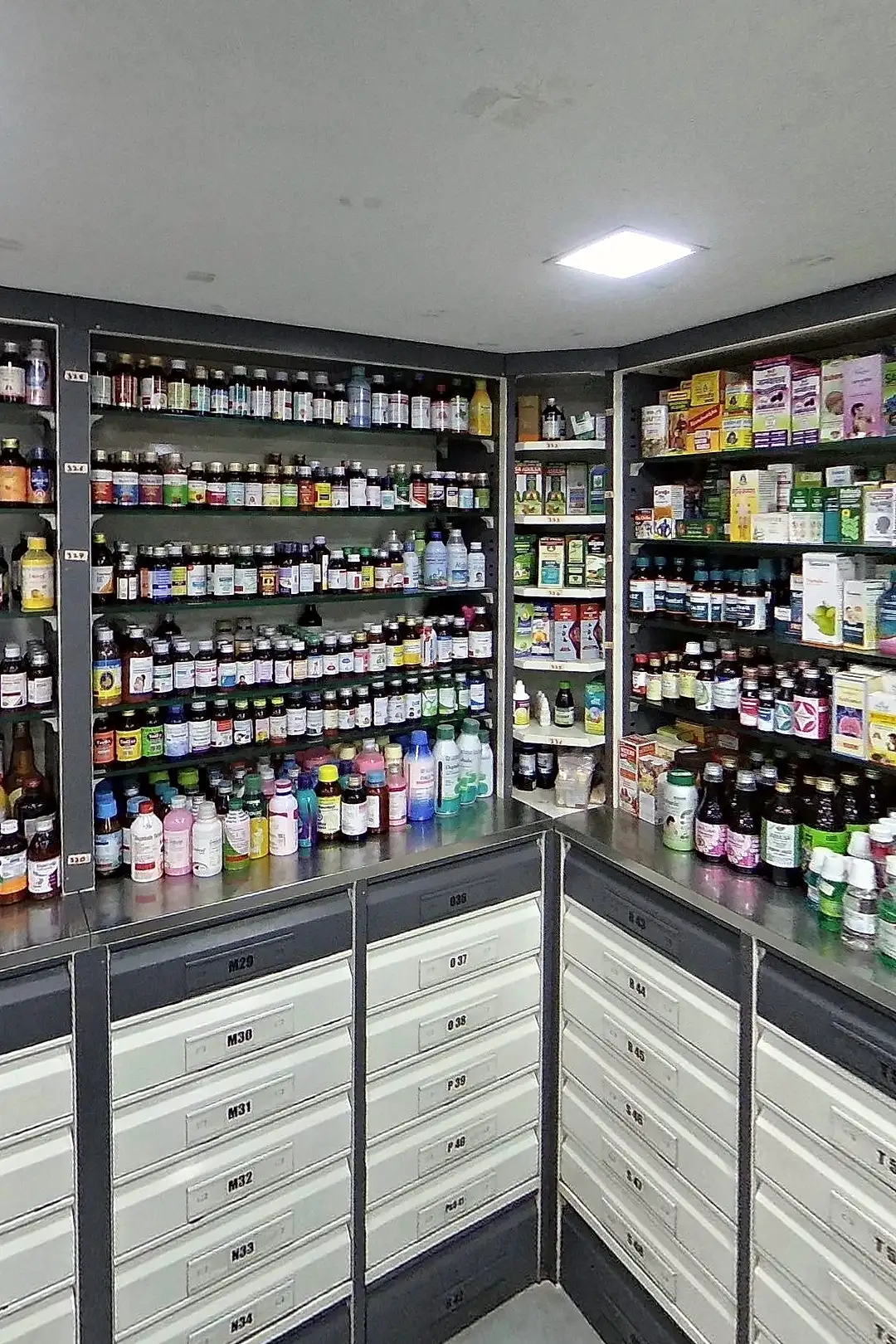 Inside a pharmacy: medicine counter, shelves of medicines and the counter